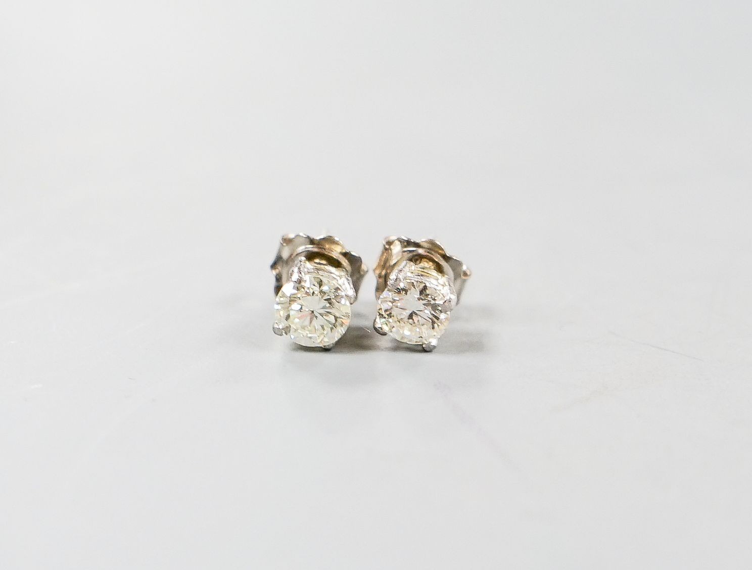 A pair of 750 white metal and solitaire diamond ear studs, gross weight 2.3 grams